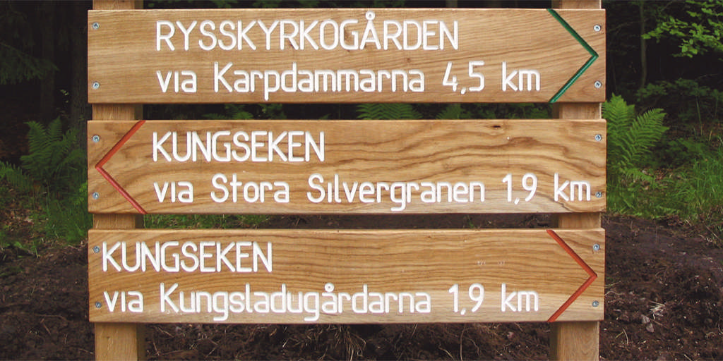 Hänvisningsskylt med fräst text, enkelsidig, dubbelrad.